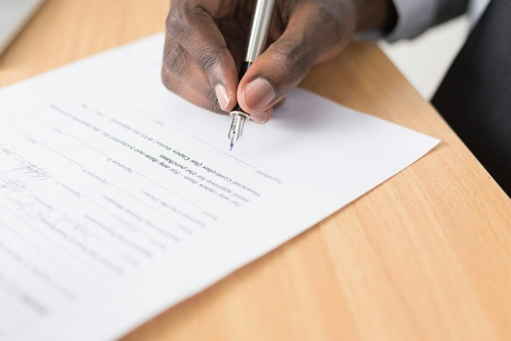 Signing an insurance policy document — car insurance requirements for registration renewal in the UAE