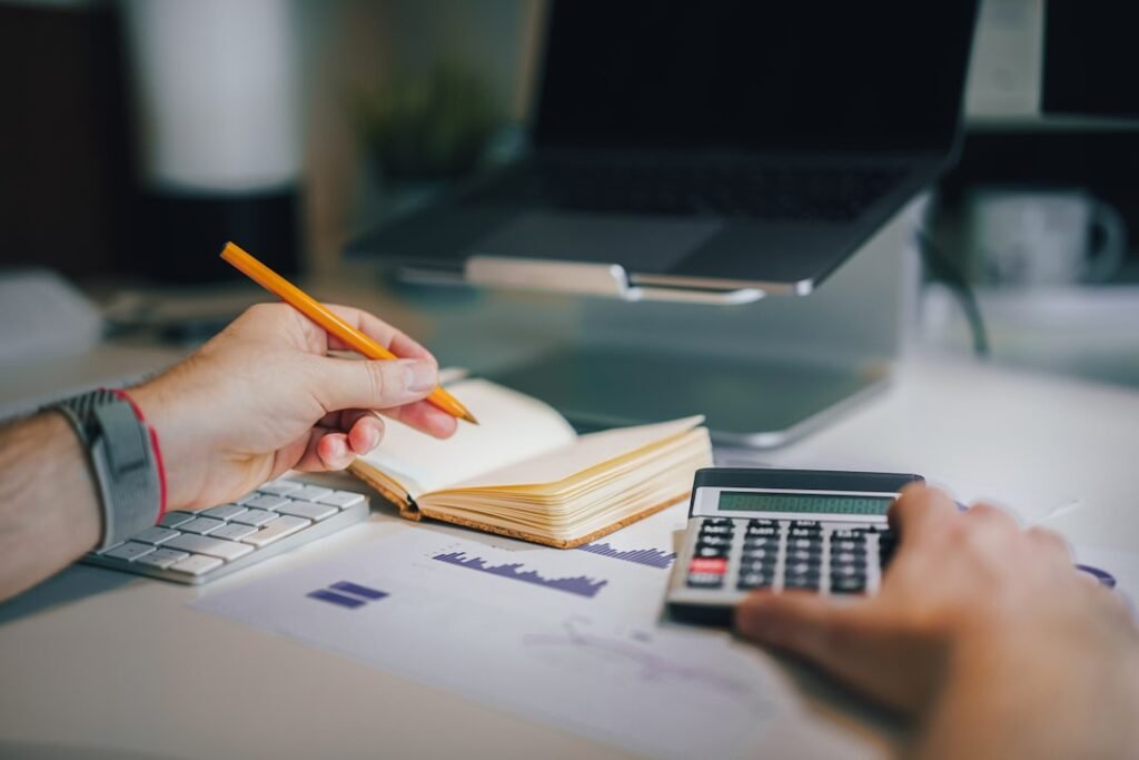 A calculator on a desk with financial documents — working out car registration renewal cost in Dubai