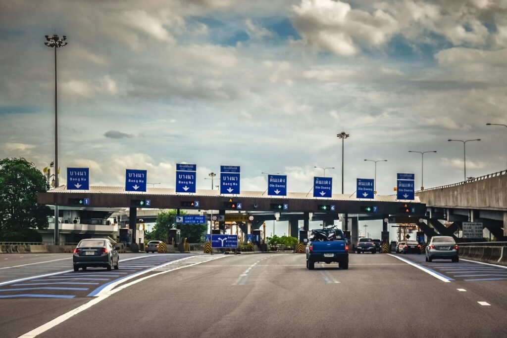 Cars passing under a highway toll gantry — clearing Salik charges before car registration renewal