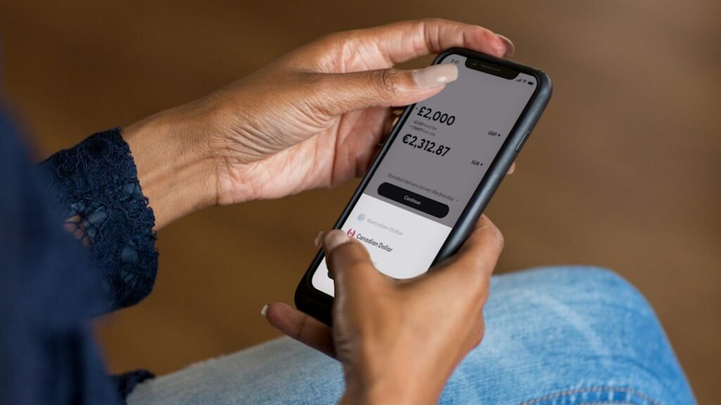 Hands holding a smartphone completing an online payment — renewing car registration online in Dubai